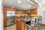 Stainless steel appliances and bar seating for 4